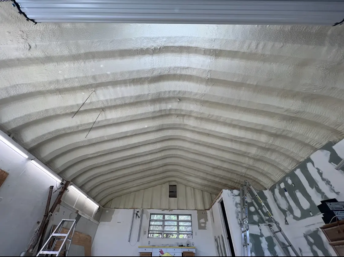 Spray polyurethane foam applied to the underside of a metal roof deck in Wildwood